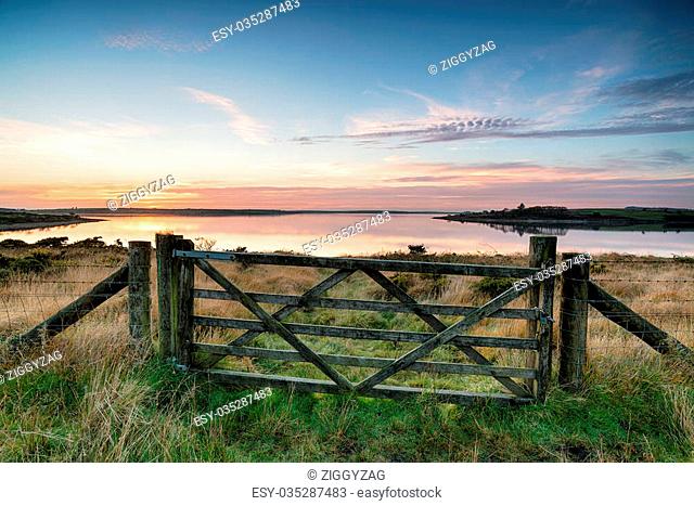 A wooden filed gate leading to Colliford Lake, a large reservoir on Bodmin Moor in Cornwall