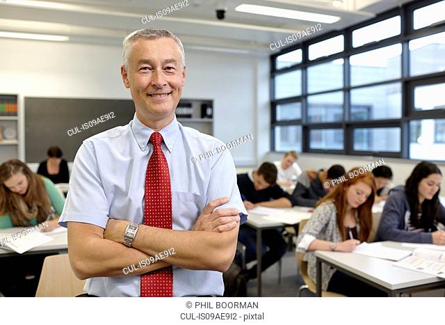 Portrait of mature male teacher in classroom
