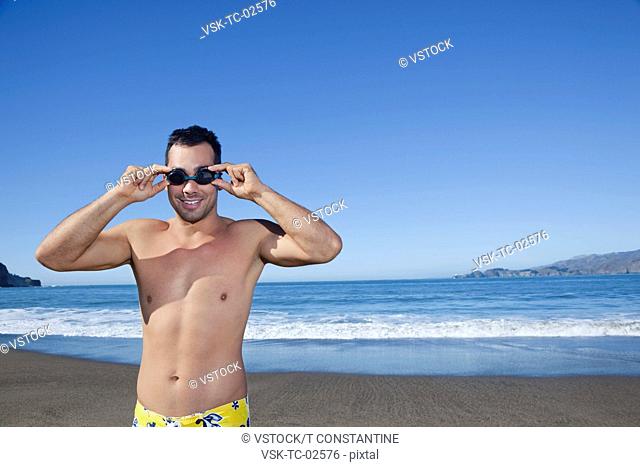 USA, California, San Francisco, portrait of man adjusting goggles on Baker Beach
