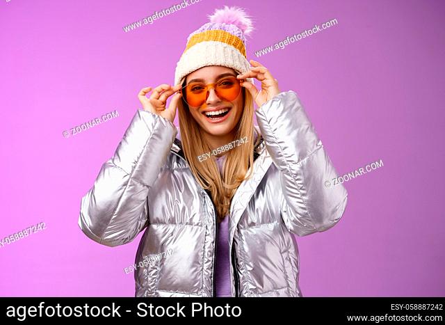 Good-looking charming happy smiling blond girlfriend having fun vacation girlfriends put on sunglasses grinning delighted wear cool silver glittering jacket...