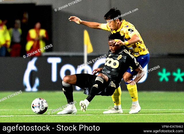 Standard's William Balikwisha and STVV's Shinji Kagawa fight for the ball during a soccer match between Sint-Truidense VV and Standard de Liege