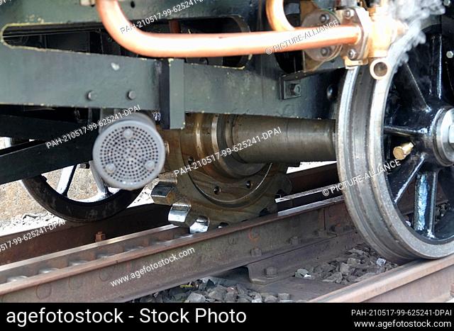 12 May 2021, Switzerland, Goldau: The cogwheel of the 148-year-old steam locomotive 7 engages the rack on the route up the Rigi mountain massif