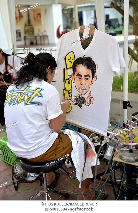 Woman airbrushing a portrait on a T-shirt, Hua Hin, Thailand