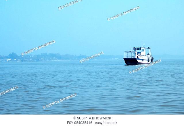 Landscape view of large and heavy rusty cargo container ship on river for transportation of crude oil. International shipment of import and export business and...