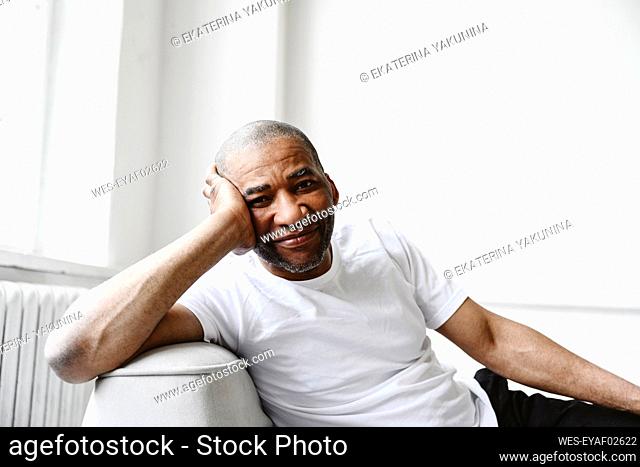 Mature man relaxing on sofa at home