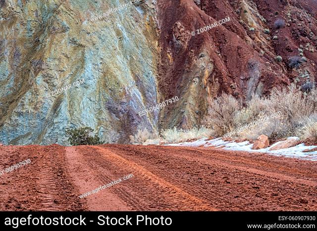 muddy canyon dirt road with a rocky cliff - Onion Creek Road near Moab, Utah, travel, vacations and recreation concept