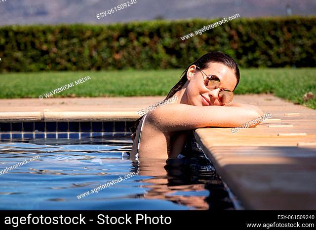 Portrait of woman with sunglasses in the pool