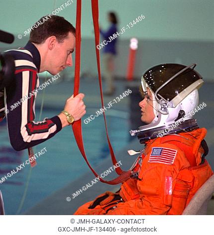 Emergency egress instructor David Pogue (left) briefs Julie Payette, STS-96 mission specialist, during her emergency egress water survival training at the...