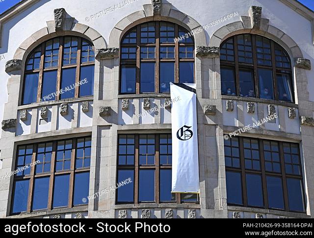 26 April 2021, Thuringia, Erfurt: A banner with the school's logo hangs on the Gutenberg Gymnasium building during a silent memorial 19 years after the rampage
