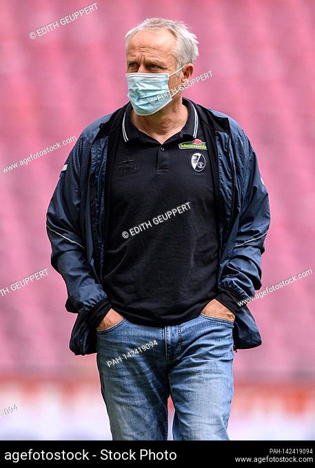 coach Christian Streich (SC Freiburg) with mouth and nose protection on the way to the TV interview. GES / Football / 1. Bundesliga: FC Cologne - SC Freiburg