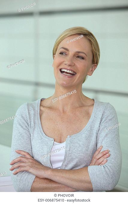 Woman laughing with her arms crossed