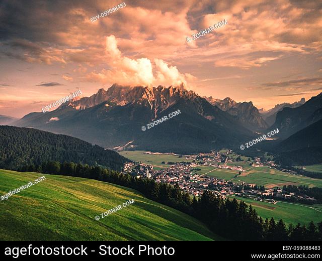 Panoramic view of famous Dolomites mountain peaks glowing in beautiful golden evening light at sunset in summer, South Tyrol, Italy Toblach