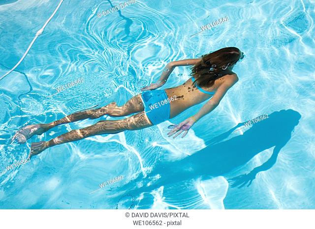 Young girl swimming under water