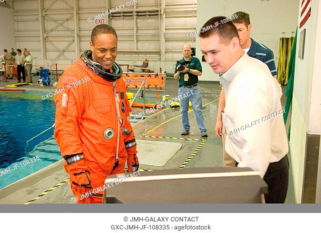 United Space Alliance (USA) crew trainer Adam Flagan (right) briefs astronaut B. Alvin Drew Jr., STS-118 mission specialist