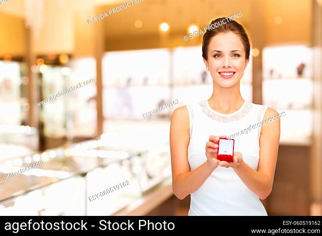 woman with ring in gift box at jewelry store