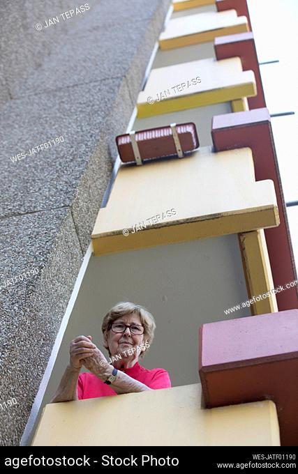 Senior woman on balcony, retirement home