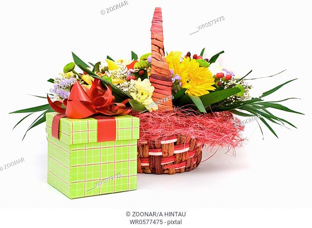 Beautiful bouquet in the basket and present box on a white background