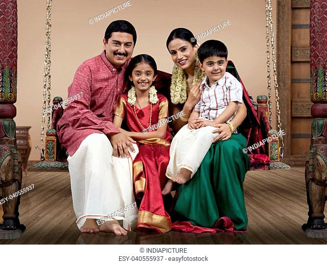 Portrait of a South Indian family sitting on a jhula