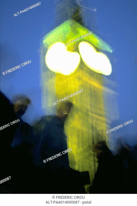 England, London, group of people in front of Big Ben at night, blurred