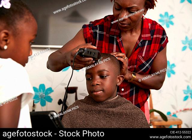 Cutting boy hair with hair trimmer Stock Photos and Images | agefotostock