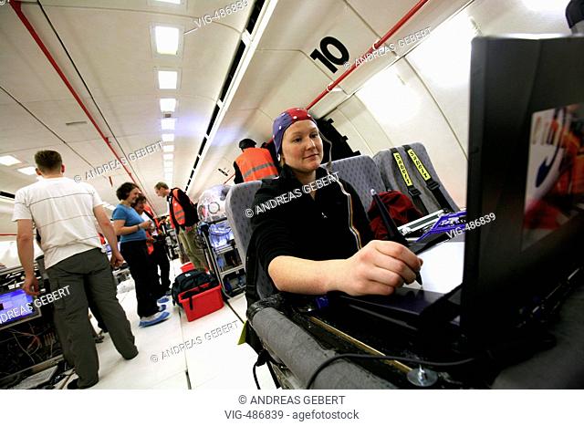 Germany, Cologne, 06.09.2007, A scientist of the German Aerospace Center (DLR) checking the performance of the lung of a test person in an Airbus A300 at Konrad...