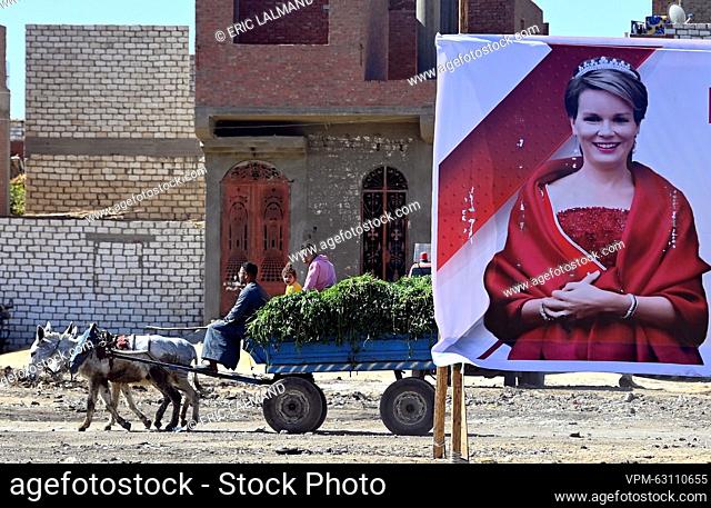 Aa horse pullig a carriage and a large poster showing an image of Queen Mathilde of Belgium pictured on the excavation site of Dayr-al-Barsha on the third day...
