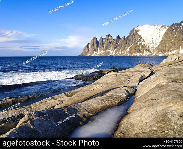 Coastal landscape at Tungeneset and the peaks Okshornan (devils teeth). The island Senja during winter in the north of Norway