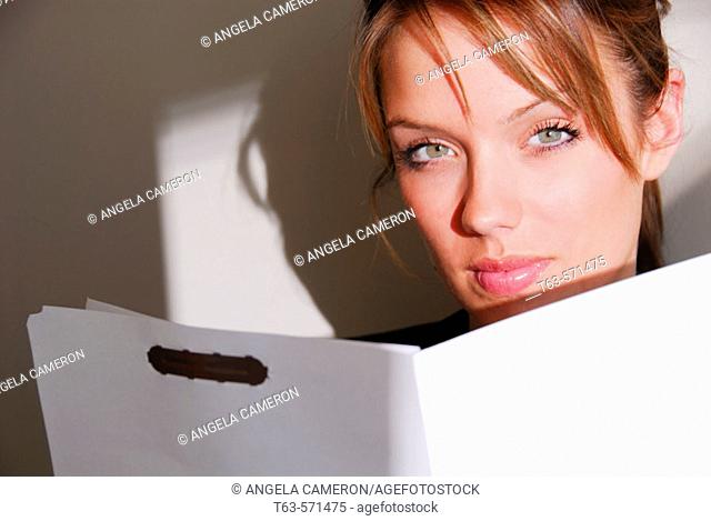20 yr old young woman holding file folder