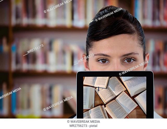 Woman with tablet showing open books against blurry bookshelf