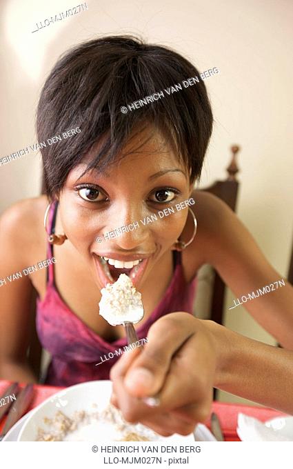 Woman eating breakfast cereal, Pietermaritzburg, KwaZulu-Natal Province, South Africa