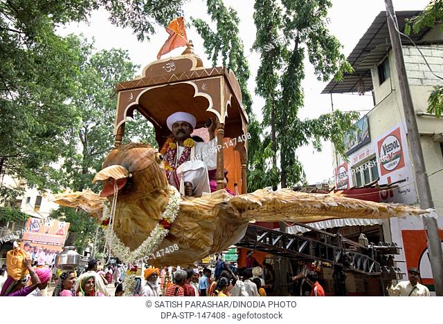 Saint Tukaram sitting on big size eagle in vari procession at Pune ; Maharashtra ; India