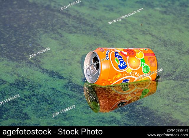 Urk, The Netherlands- July 31, 2009: Soda can of fanta floating in Dutch harbor Urk with many algae