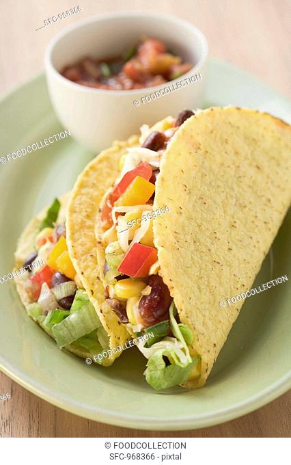 Two vegetable tacos, salsa in small bowl Mexico