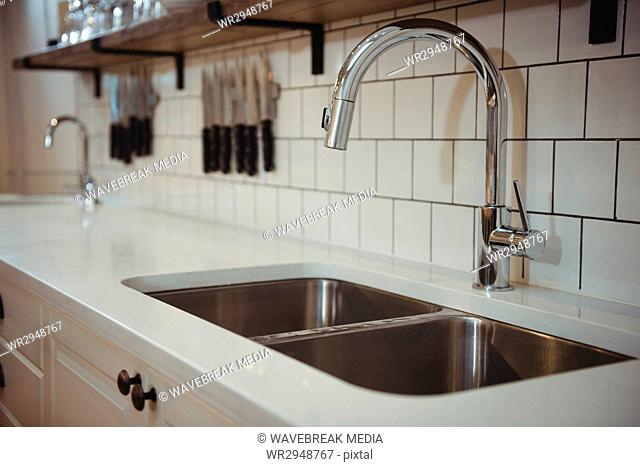 Chrome sink and faucet in professional kitchen