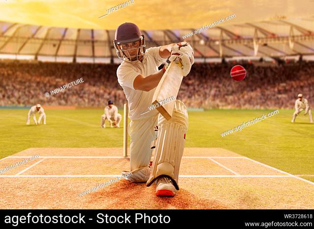 Batsman Hitting the Ball During Cricket Match In Stadium