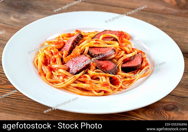 Portion of beef steak linguine pasta