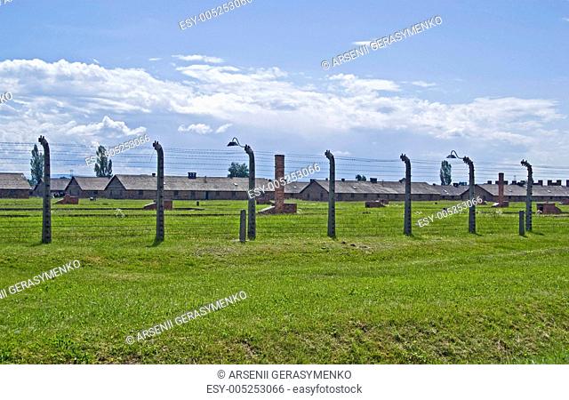 Wire fence and barracks in Birkenau concentration camp