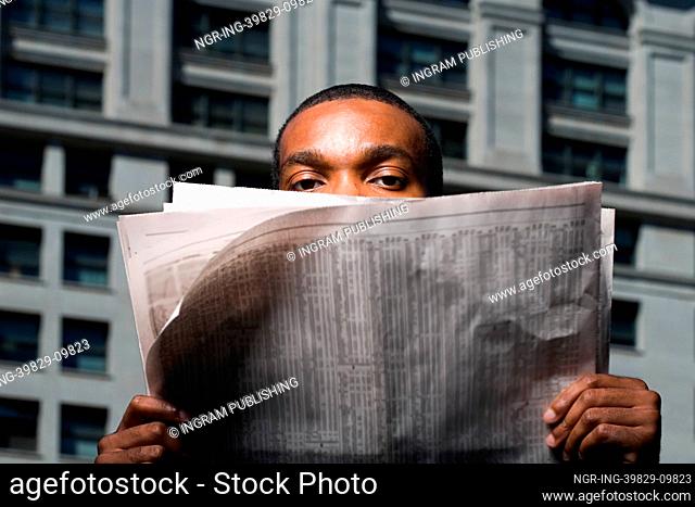 Man looking over newspaper