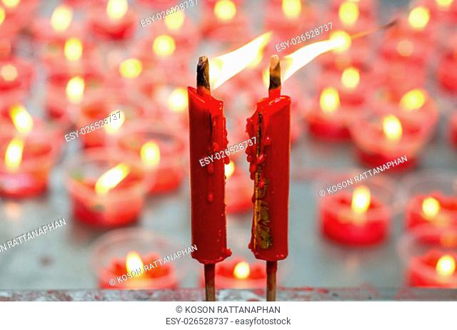 Burning red candle at chinese shrine for making merit in chinese new year festival. Pray for New Year, Lighting incense to Buddha