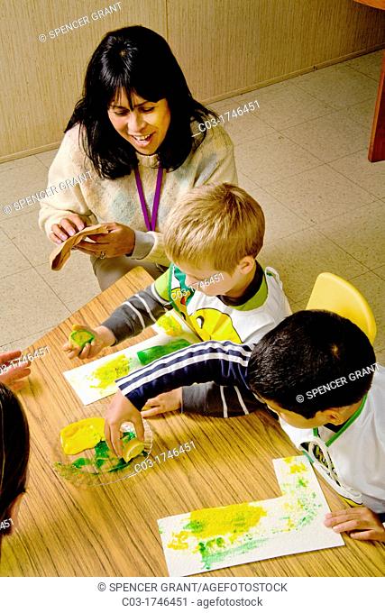 A teacher watches as blind children use yellow and green gel to signify lemon and lime -- both starting with the letter 'L' -- to form the letter 'L' by touch...