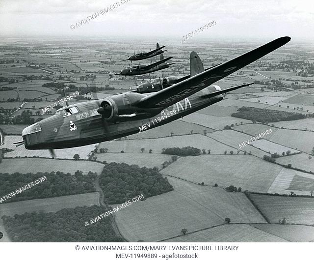 RAF Vickers Wellington Bomber of 9th Sqn, Based in Scampton, flying in formation over Fields