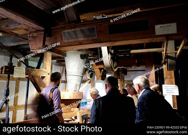 01 September 2023, Saxony, Bad Düben: Visitors to the so-called Upper Mill from the 16th century stand inside the sight. The trail infrastructure of the Dübener...