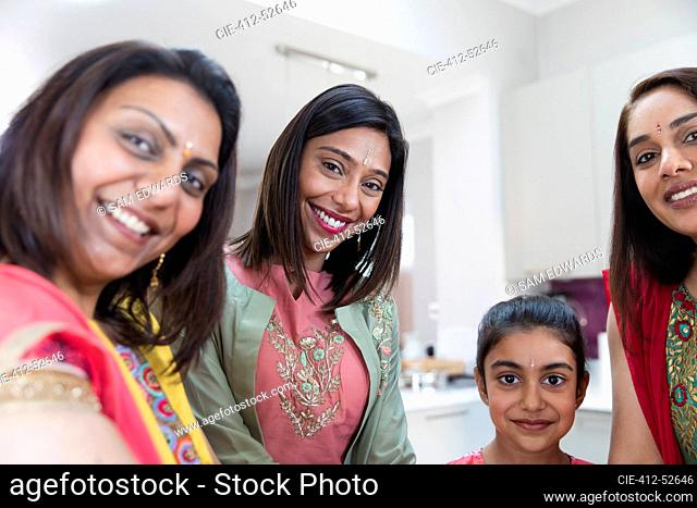 Portrait happy Indian women and girl in saris and bindis