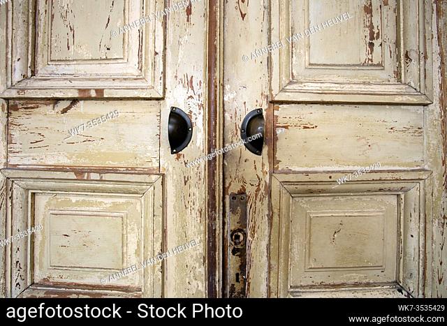 Vintage old wooden door with cracks background texture, peeling paint retro design closeup