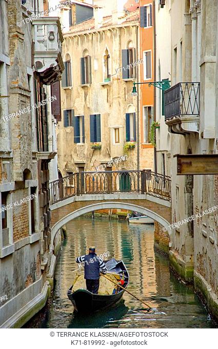 Picturesque small canals in Venice with boats and small bridges