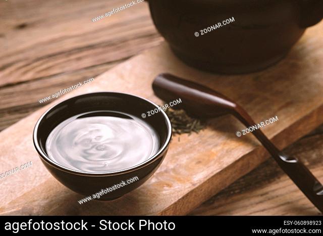Chinese bowl with tea on the wooden table horizontal