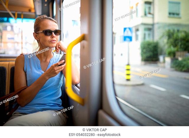 Young woman on a city tram, heading for the office early, before the rush hour begins