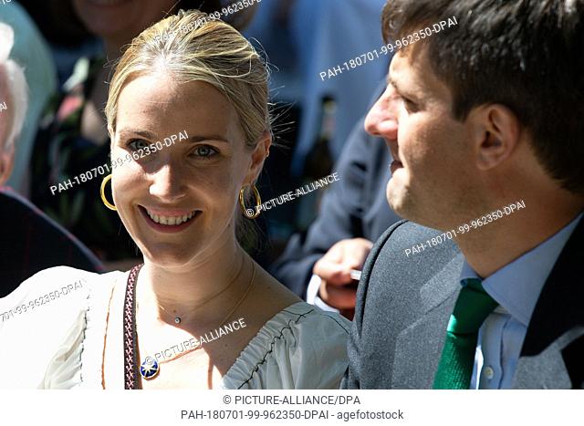 01 July 2018, Germany, Hanover: Ernst August Jr. of Hanover and his wife Ekaterina watch the parade of the Marksmen's Festival