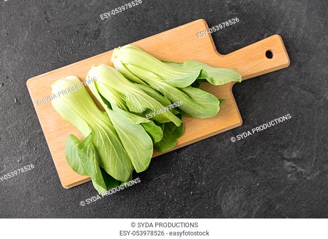 bok choy chinese cabbage on wooden cutting board