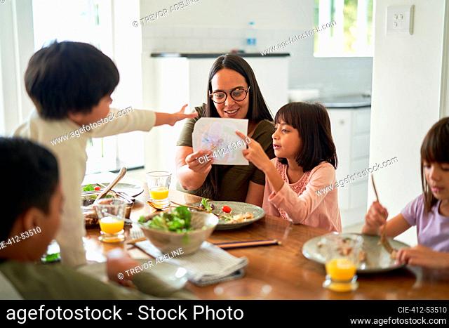 Mother and kids eating lunch at dining table